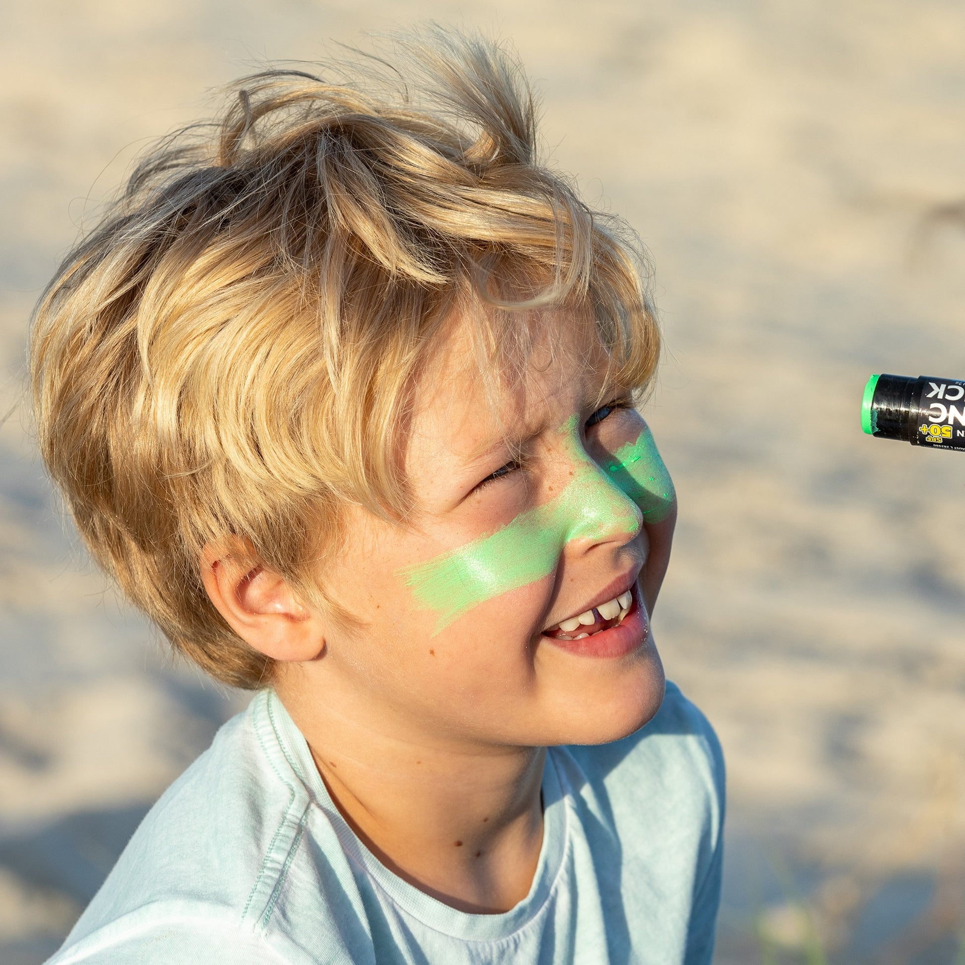 Un padre aplica a su hijo el protector Solar en Stick Verde SPF 50+ de Sun Zapper