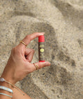 Una mano sostiene el pequeño Stick Labial de protección solar Sun Bum Original SPF 30 Sabor Sandía