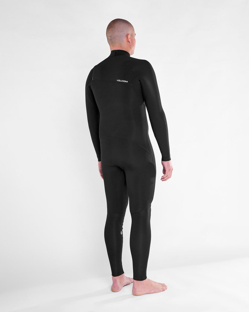 Vista lateral tasera del traje de neopreno VOLCOM 4/3MM Chest Zip Fullsuit en color Negro, mostrando el perfil yel logo en la espalda