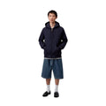 Carhartt WIP Landon Short azul stone washed, modelo vista frontal cuerpo completo, corte holgado cintura regular combinado con sudadera con capucha.
