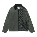 Chaqueta Carhartt WIP OG Detroit Jacket en color Raven / Black abierta, mostrando el forro interior acolchado en rombos y el cuello de pana en contraste.