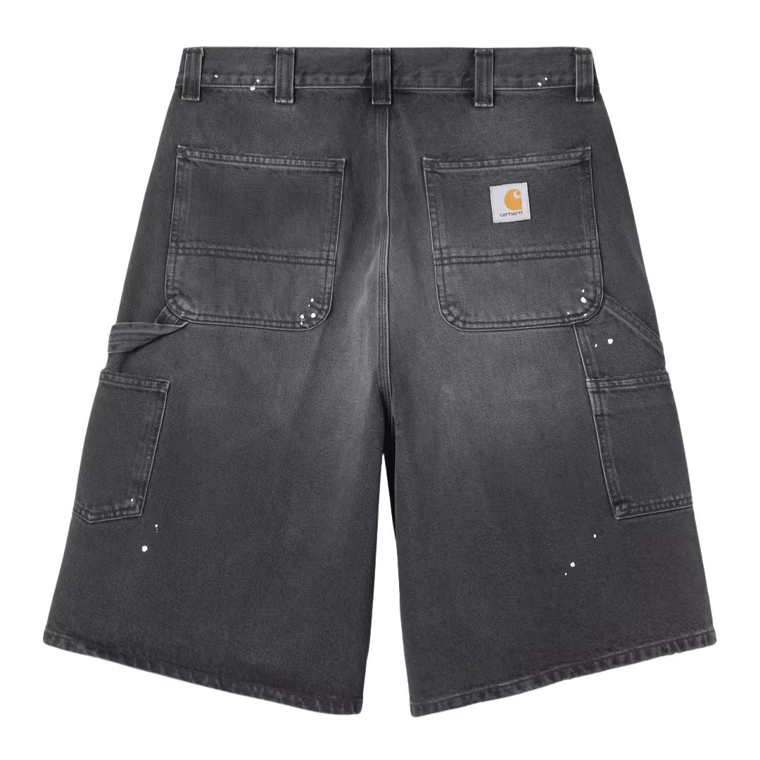 Carhartt WIP OG Single Knee Short negro destroy wash, vista trasera producto plano, bolsillos traseros grandes, Square Label tejida y pintura splatter visible.