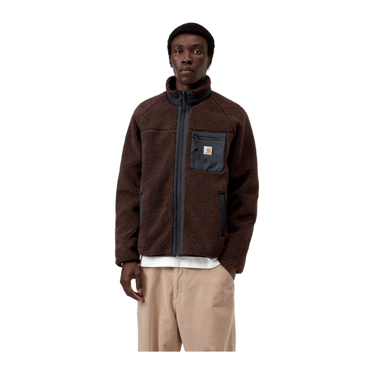 Modelo con la chaqueta forro polar Carhartt WIP Prentis Liner en color Palisander / Black cerrada, de pelo grueso con cuello alto, cremallera y bolsillo en el pecho.