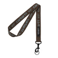 Cinta llavero Carhartt WIP Script Lanyard en color marrón Vitola con logotipo en azul Citadel y gancho metálico negro.