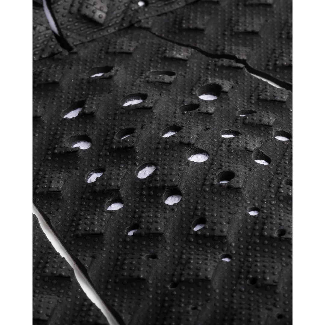 Detalle de los cortes de contraste y perforaciones del patrón Diamond Loc II negro del grip de surf Creatures of Leisure Griffin Colapinto Signature con tecnología Thermo-Lite.