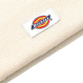Detalle cercano del logo Dickies en el gorro Gibsland Beanie color ecru destacando el tejido de punto de algodón.