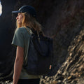 Mujer al aire libre con la mochila Fjällräven High Coast Totepack en modo mochila