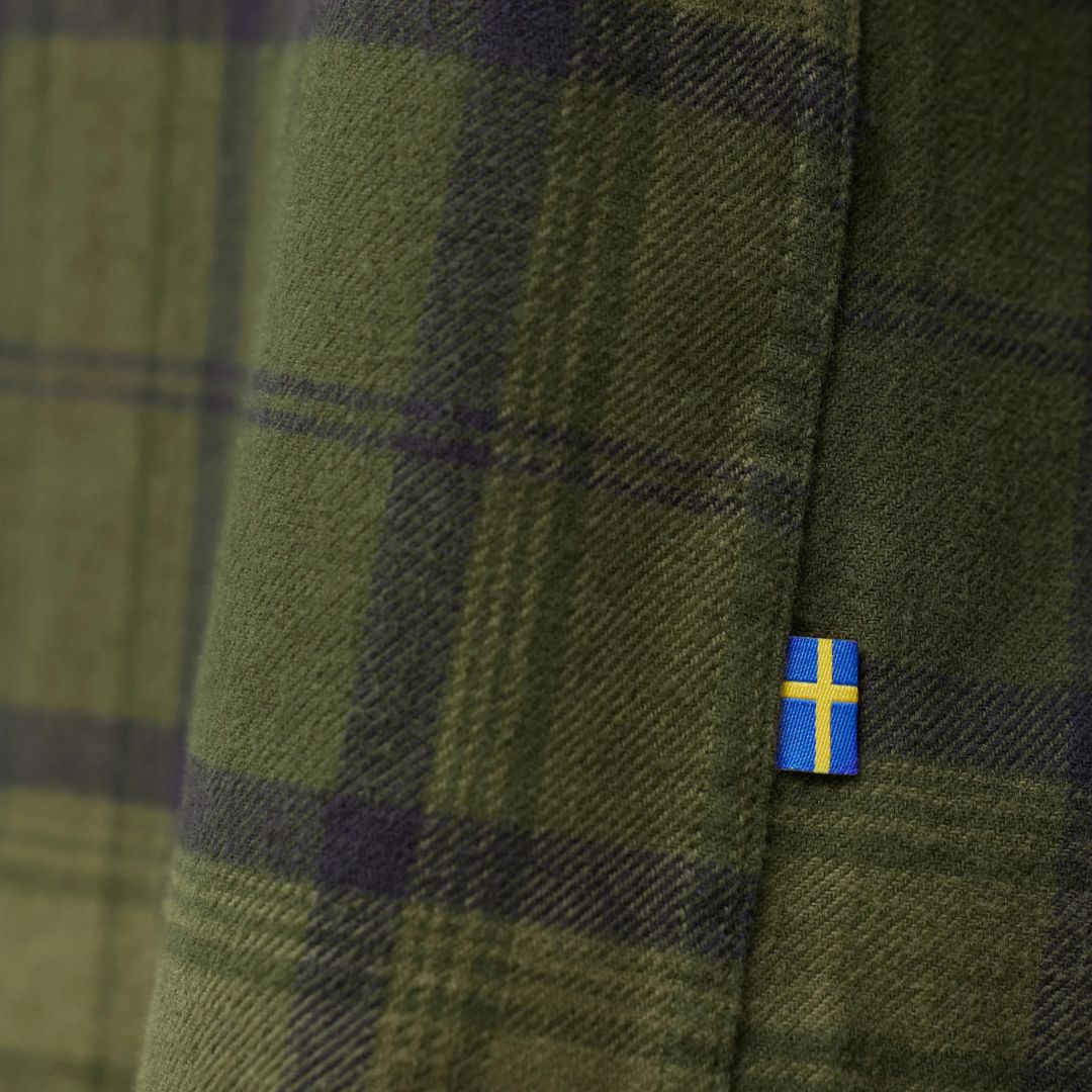 Detalle de tejido de la camisa Fjällräven Övik Twill Shirt M con etiqueta de la bandera sueca.