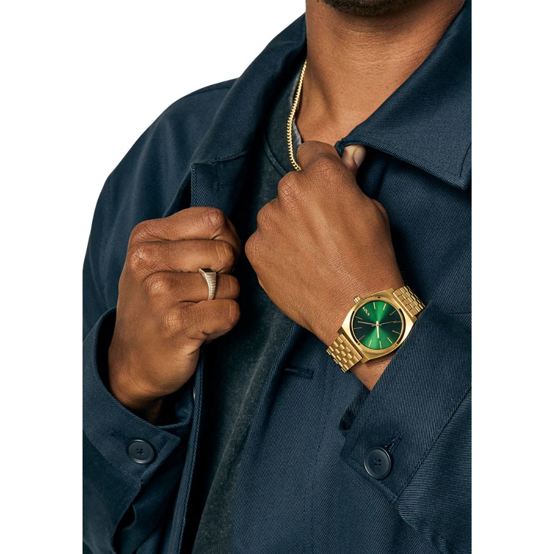 Reloj Nixon Time Teller Gold Green Sunray mostrando lateral del brazalete dorado y caja pulida.