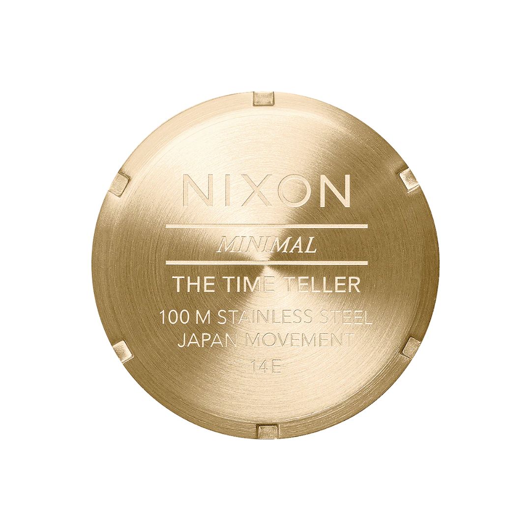 Reloj Nixon Time Teller dorado con esfera rojo oxblood sunray visto desde el reverso del brazalete.