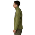 Patagonia Men's R1 Air Fleece Jacket en color caper green, vista lateral con modelo, mostrando el corte slim fit, tejido jacquard en zigzag, panel del bolsillo pectoral en tejido liso verde oliva y logo R1 en el bajo de la manga.