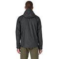 Patagonia Torrentshell 3L color negro, vista trasera en modelo: capucha ajustable, construcción triple capa H2No® en nailon ripstop ECONYL® 100% reciclado.