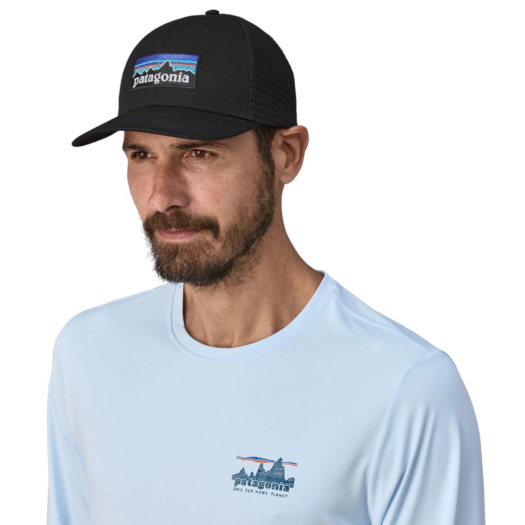 Patagonia P-6 Logo Trucker Hat negra gorra trucker con logo frontal, panel frontal de algodón orgánico y malla trasera transpirable vista frontal con modelo.