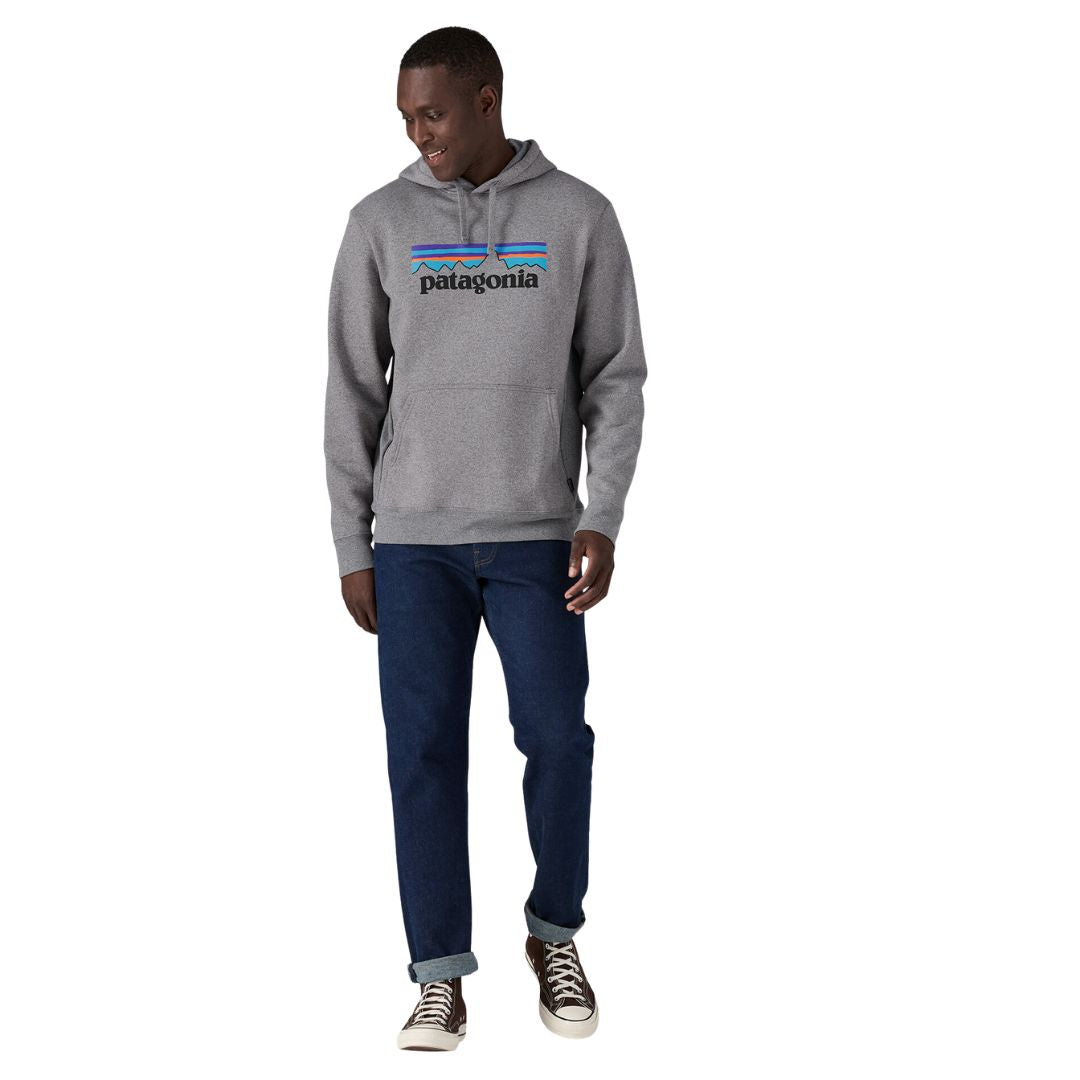 Hombre con sudadera Patagonia P‑6 Logo Uprisal Hoody en color Gravel Heather, estilo casual con capucha y gráfico frontal.