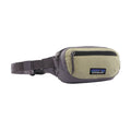 Riñonera Patagonia Terravia Mini Hip Pack en color gris y beige (Weathered Stone), vista de perfil con la cremallera cerrada, el bolsillo frontal y el parche Patagonia.