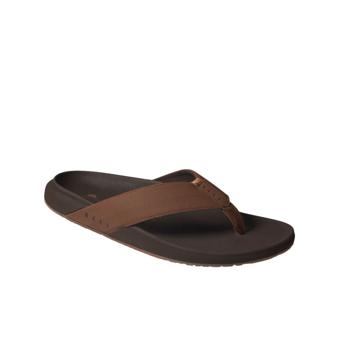 Chanclas Reef The Raglan marrón java con tira acolchada texturizada y plantilla ergonómica de EVA con suela antideslizante.
