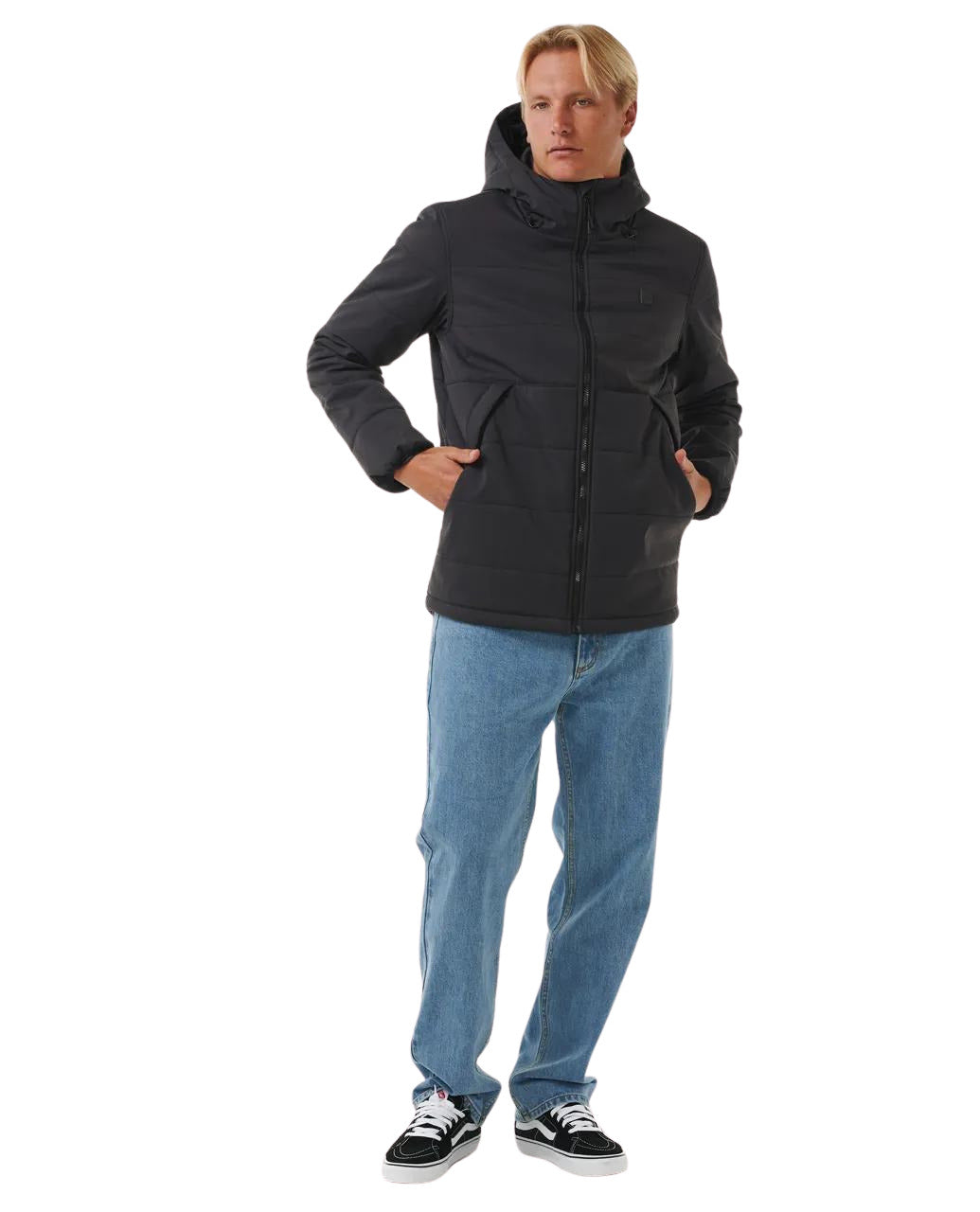 Hombre con la Chaqueta impermeable Rip Curl Anti Series Ridge Jacket Negra y pantalón vaquero