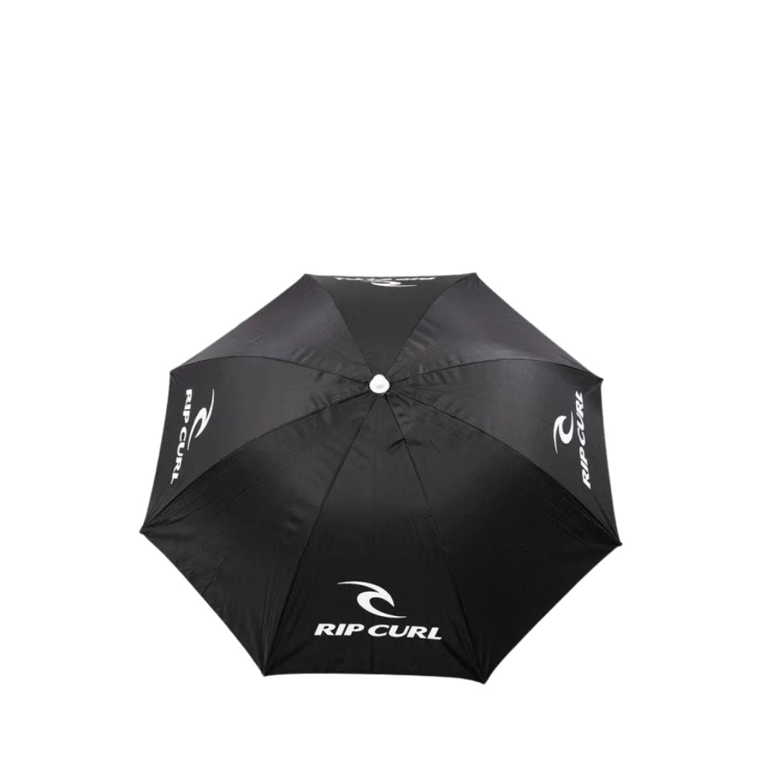 Vista superior de la sombrilla Rip Curl Brand Beach Umbrella desplegada en color negro con logotipo blanco