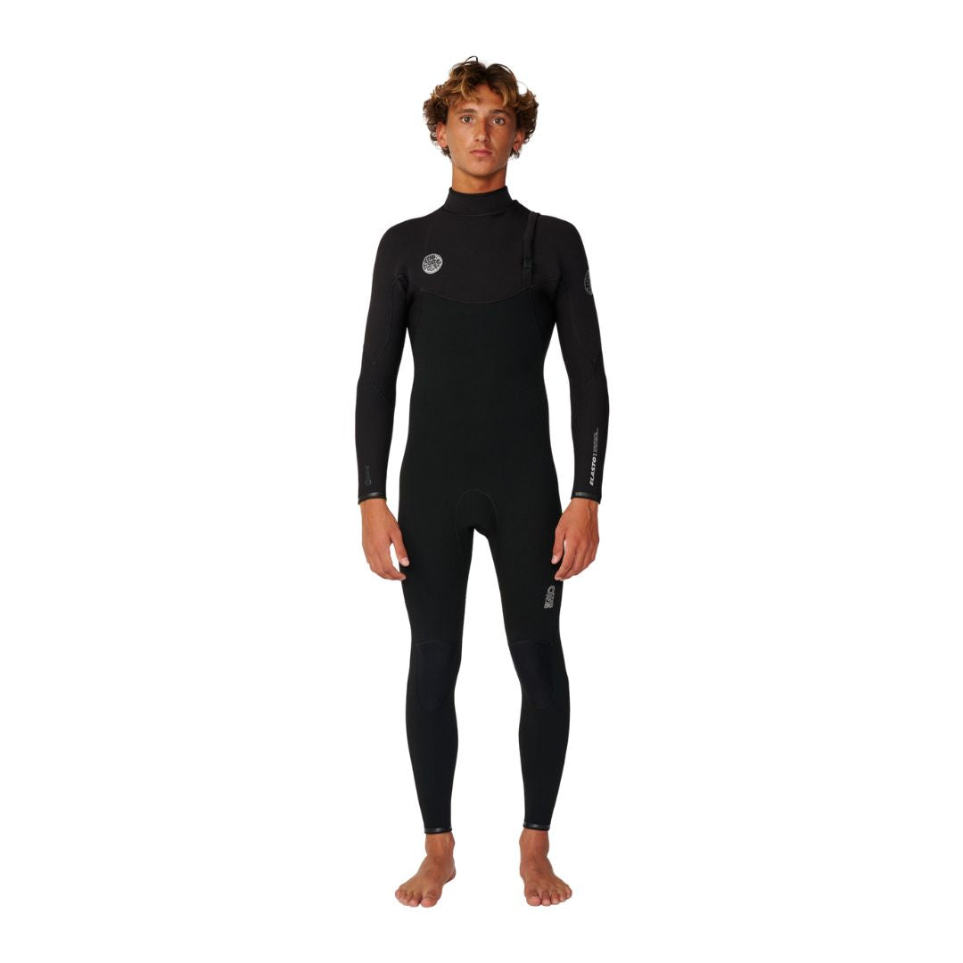 Traje de surf Rip Curl Elasto Zip Free 5/4 en negro, vista frontal completa sobre modelo, con logo circular Rip Curl Wetsuits en el pecho y detalle Elasto en la manga.
