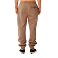 Pantalón Rip Curl Icons of Surf Trackpant en Walnut, vista trasera completa, con el bolsillo con cremallera y puños elásticos en los tobillos.