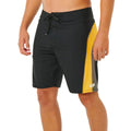 Bañador surf Rip Curl Mirage Archive amarillo y negro, vista lateral con panel cut-and-sew amarillo, piping gris, bolsillo cremallera y logo heat transfer blanco.