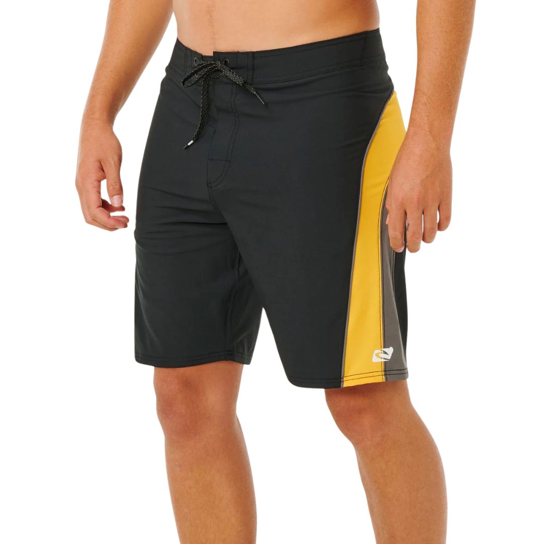 Bañador surf Rip Curl Mirage Archive amarillo y negro, vista lateral con panel cut-and-sew amarillo, piping gris, bolsillo cremallera y logo heat transfer blanco.