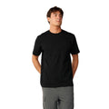 Rip Curl S-Series VaporCool Embroid Tee en color negro, vista frontal con las manos atrás, mostrando el cuello redondo y el logo bordado en el pecho.