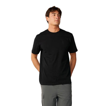 Rip Curl S-Series VaporCool Embroid Tee en color negro, vista frontal con las manos atrás, mostrando el cuello redondo y el logo bordado en el pecho.