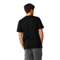 Camiseta Rip Curl S-Series VaporCool Embroid Tee negra, vista trasera completa mostrando la etiqueta tejida Search cosida en el bajo, corte relajado y mangas cortas.