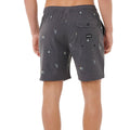 Bañador surf hombre Rip Curl Skelly Breach Volley negro, vista trasera con bolsillo con solapa, botón negro y etiqueta Rip Curl, estampado yardage skelly.