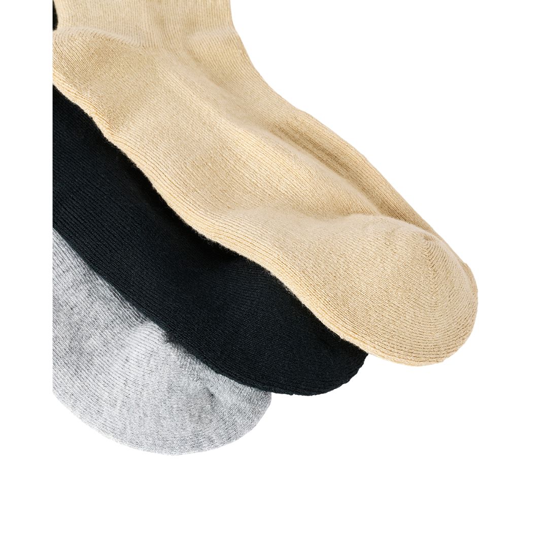 Primer plano de la puntera y textura de punto de los calcetines Rip Curl Wetty Crew Sock en beige, negro y gris jaspeado, mostrando el acabado del tejido.