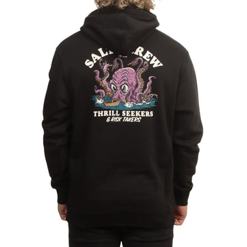 Modelo de espaldas con la sudadera Salty Crew Kraken Monster en negro, luciendo el estampado completo del kraken atacando un barco junto al texto Thrill Seekers & Risk Takers.