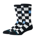 Stance Chef Check Crew black con patrón checker blanco y negro, calcetines crew con detalle azul y refuerzo en talón y puntera negra.