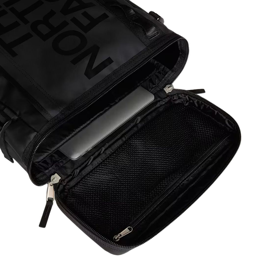 Mochila The North Face Base Camp Fuse Box negra abierta, mostrando funda acolchada para portátil.