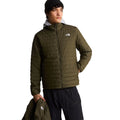 Modelo llevando solo la capa interior acolchada de la chaqueta The North Face Carto Mono Triclimate en New Taupe Green, con la capa exterior sujeta en la mano.