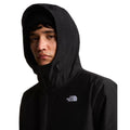 Modelo con la capucha puesta de la chaqueta The North Face Carto Mono Triclimate negra, de cerca, con cordones de ajuste en el cuello y el logo bordado en el pecho.
