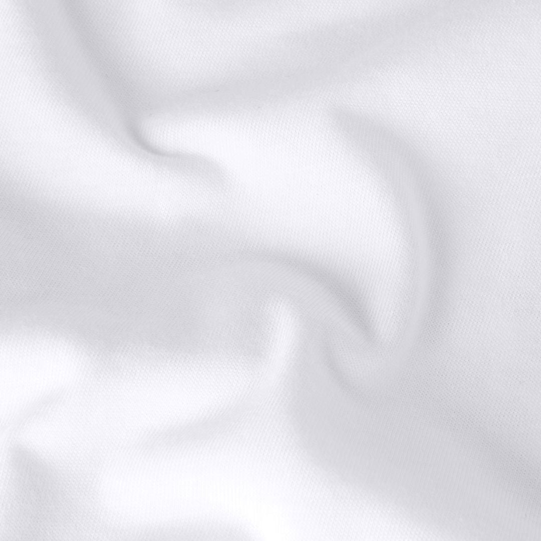 Detalle del tejido de punto en algodón blanco TNF White de la camiseta THE NORTH FACE Expedition Celebration Oversized T-Shirt.