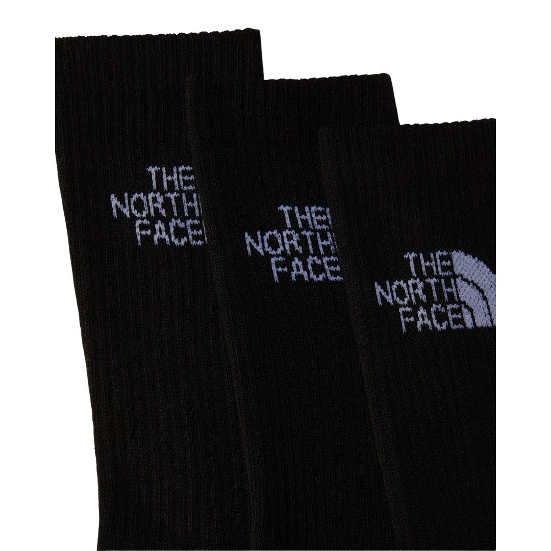 Detalle en primer plano de 3 pares de calcetines The North Face Multi Sport Cushion en negro, mostrando el logo "The North Face" bordado y el acanalado del puño.
