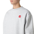 Sudadera The North Face Red Box Crew color Classic Grey Heather en modelo hombre, detalle frontal.