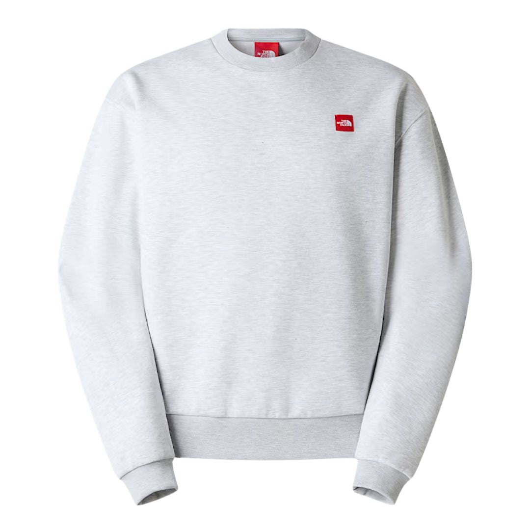 Sudadera The North Face Red Box Crew color gris jaspeado Classic Grey Heather con logo rojo bordado en el pecho.