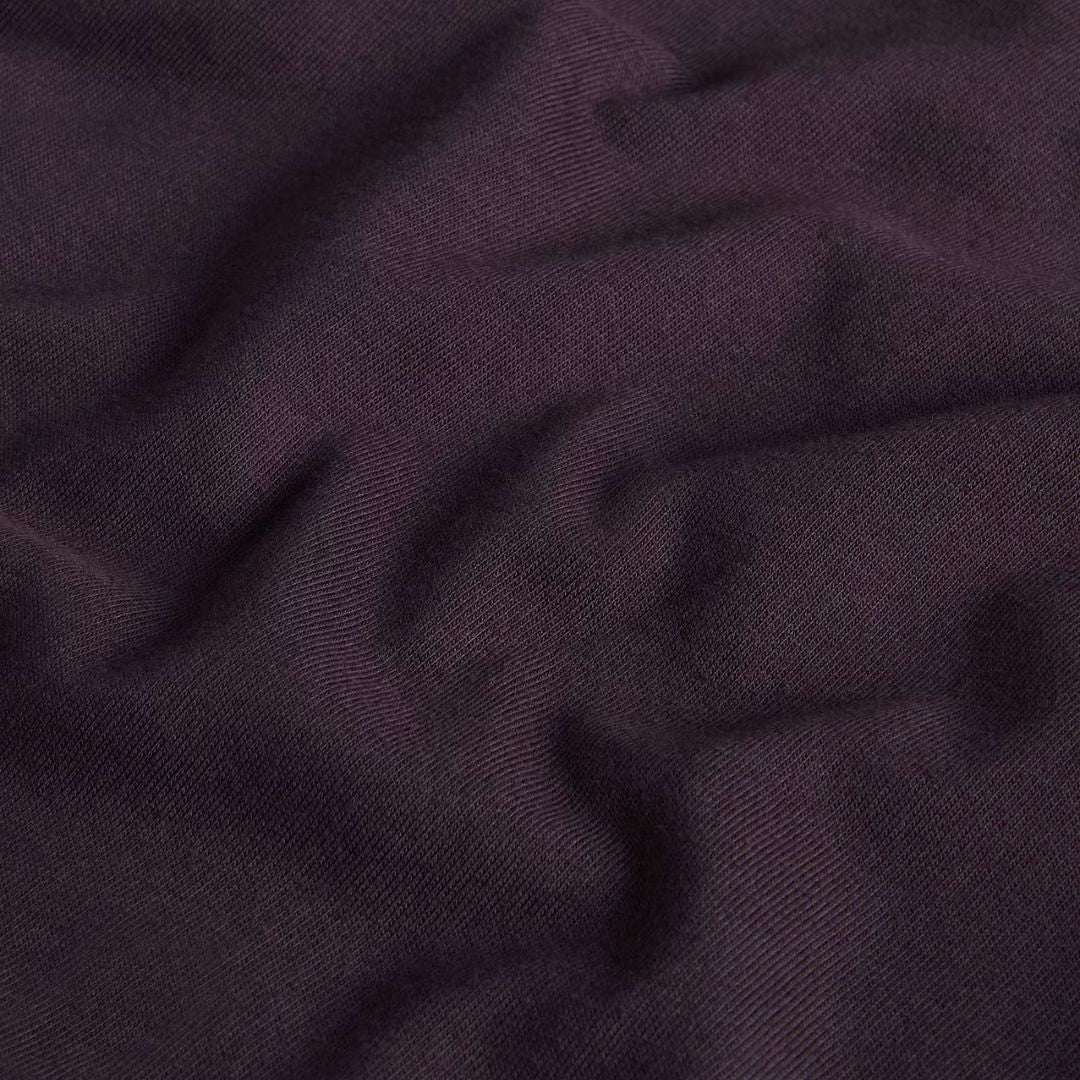 Detalle de tejido de algodón regenerativo color obsidian de la camiseta The North Face Red Box, mostrando de cerca la textura de punto y el tono grisáceo violáceo.