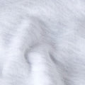 Detalle macro del tejido del pantalón de chándal The North Face Red Box en gris jaspeado TFN Classic, mostrando la textura afelpada del algodón.
