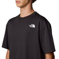 Camiseta The North Face SS NSE Oversized Tee en negro, modelo masculino mostrando el logotipo blanco en el pecho.

