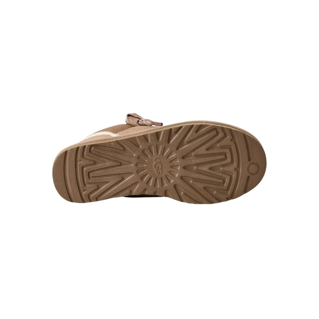 Suela de la zapatilla UGG Lowmel en color sand mostrando el dibujo direccional de la banda de rodadura de EVA de caña de azúcar y el logotipo UGG grabado.