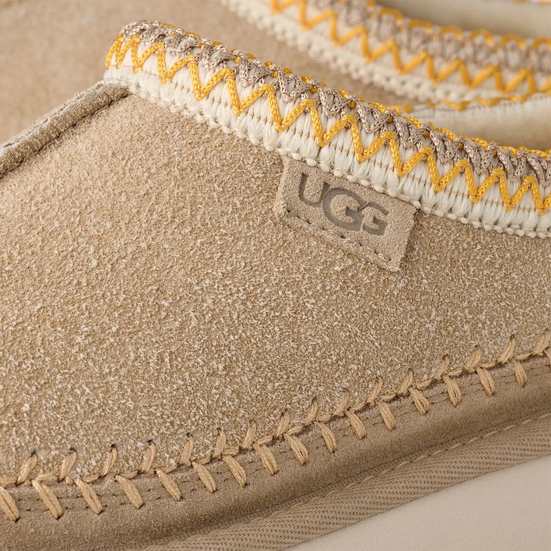 Primer plano del ribete trenzado UGGbraid en poliéster reciclado de las UGG Tasman Biarritz color mustard seed.