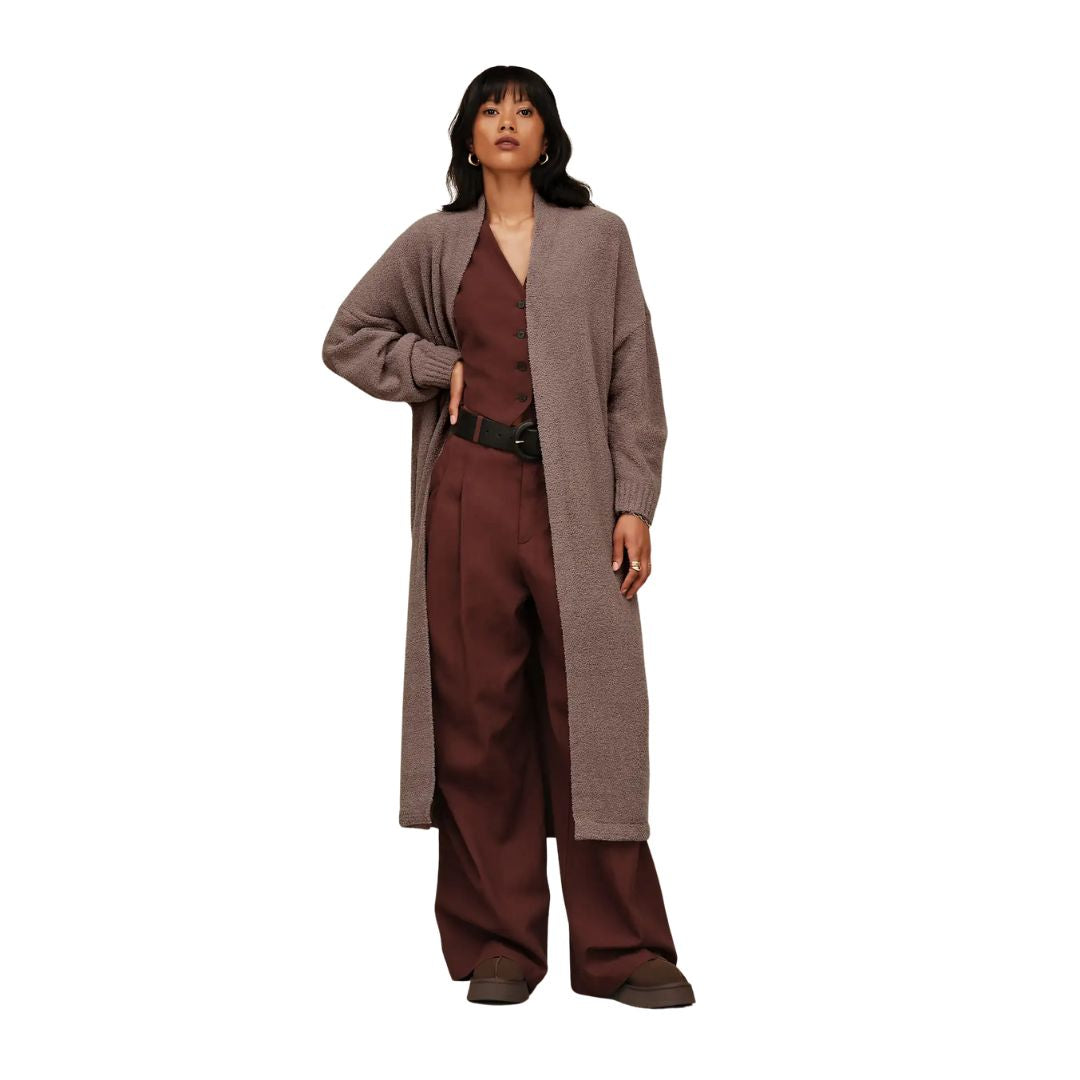 Mujer con outfit marrón vistiendo zuecos UGG Tazz II color Dusted Cocoa de ante con plataforma y ribete trenzado.