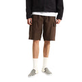 Modelo con Vans Range Cargo Shorts marrón de corte loose fit, bermudas cargo 100% algodón con bolsillos laterales con solapa, cintura elástica con cordón y bolsillos delanteros inclinados.
