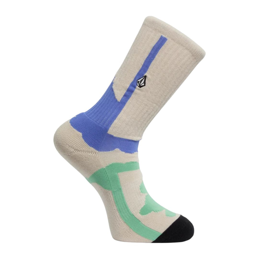 Calcetín Volcom Carrau Print Mixer Sock en estampado pastel beige y azul con detalle verde en la planta, vista de perfil con el logo de la piedra bordado.