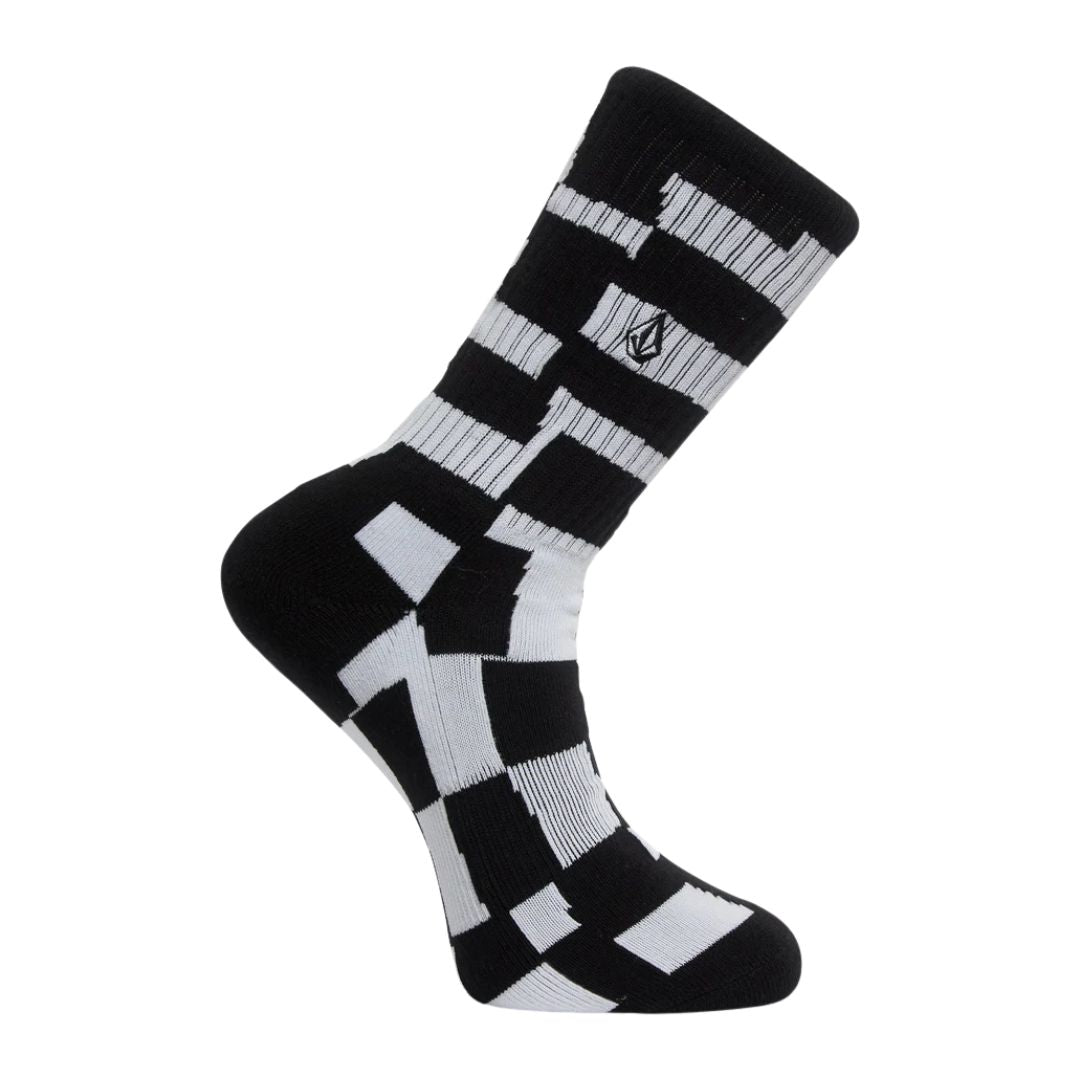 Calcetín Volcom Carrau Print Mixer Sock en estampado geométrico blanco y negro, vista de perfil con el logo de la piedra Volcom bordado en la caña.