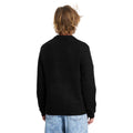 Vista trasera de hombre con jersey Volcom Edmonder II en color negro, mostrando el ajuste en la espalda y las mangas largas del tejido de punto grueso.